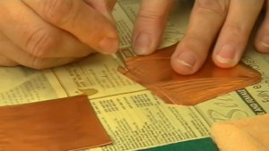 Repoussé with copper shim